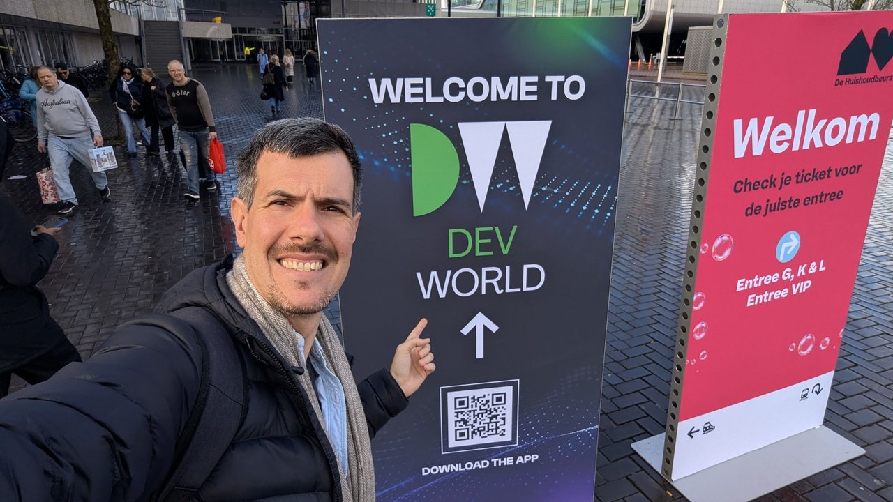 Luca Berton pointing at the Welcome to DevWorld sign outside RAI Amsterdam