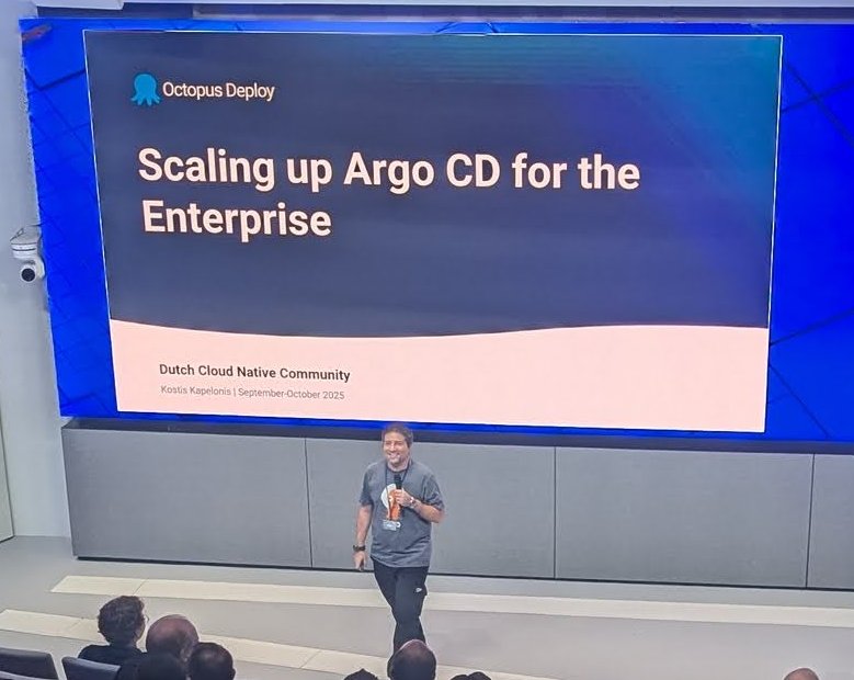 Kostis Kapelonis on stage under the Octopus Deploy title slide, Scaling up Argo CD for the Enterprise, Dutch Cloud Native Community