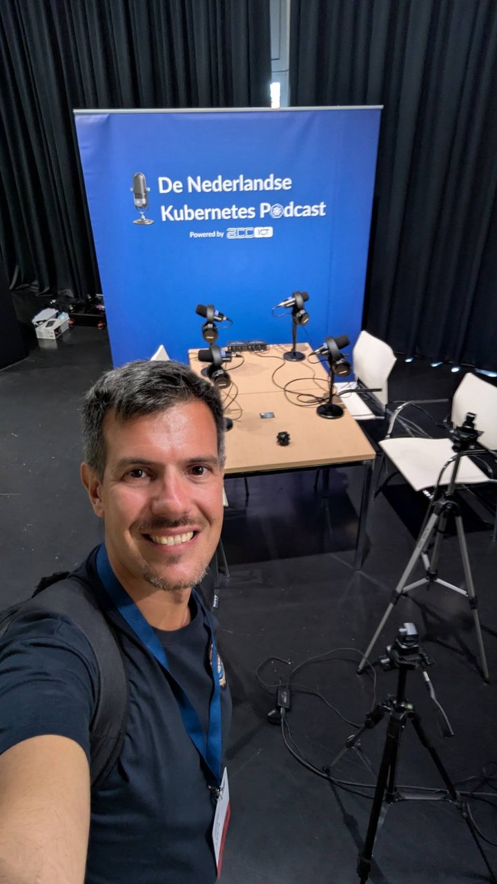 Luca Berton next to the De Nederlandse Kubernetes Podcast recording corner, with microphones set up on a table