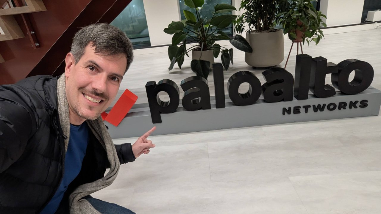 Luca Berton pointing at the Palo Alto Networks logo sign in the Amsterdam office