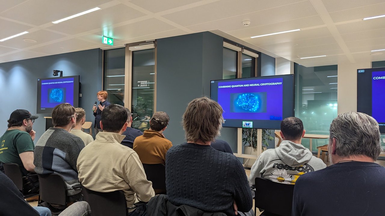 The speaker presenting the Combining quantum and neural cryptography slide to the meetup audience