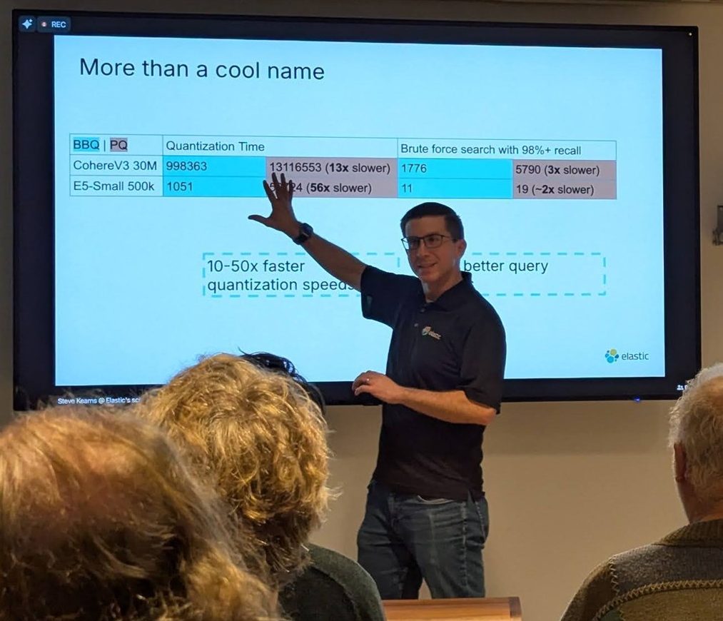 Steve Kearns pointing at the More than a cool name table comparing BBQ and PQ quantization time and brute-force search time for CohereV3 30M and E5-Small 500k