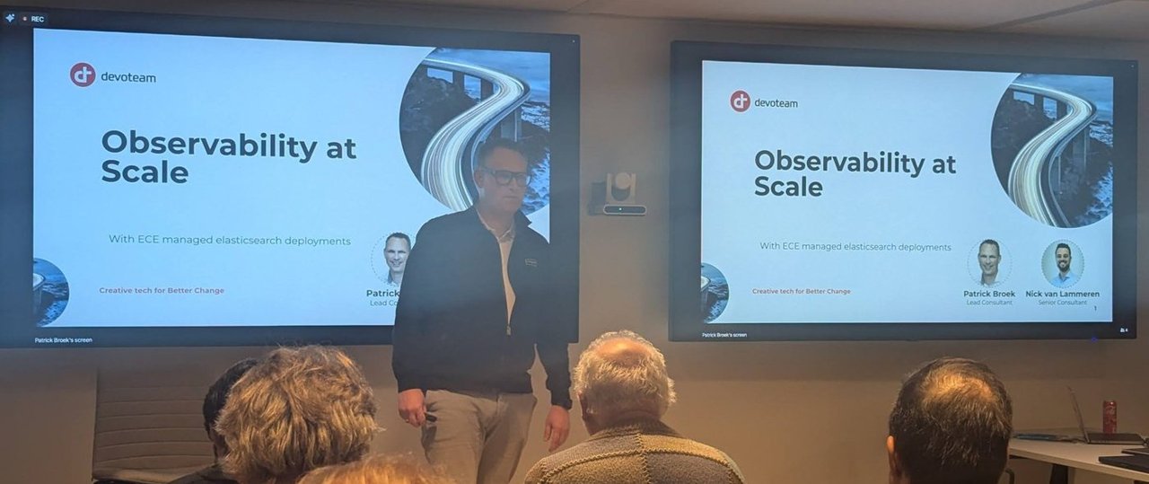 Patrick Broek on stage in front of the Devoteam title slide Observability at Scale, With ECE managed elasticsearch deployments