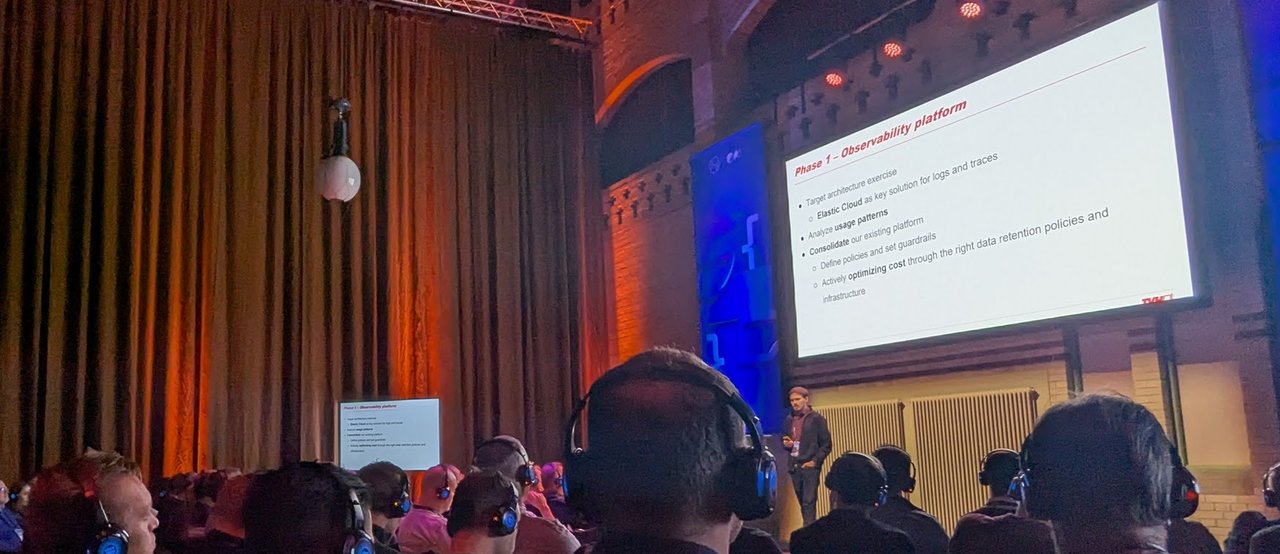 The TVH Phase 1 Observability platform slide listing a target architecture exercise, Elastic Cloud for logs and traces, and cost optimisation through retention policies