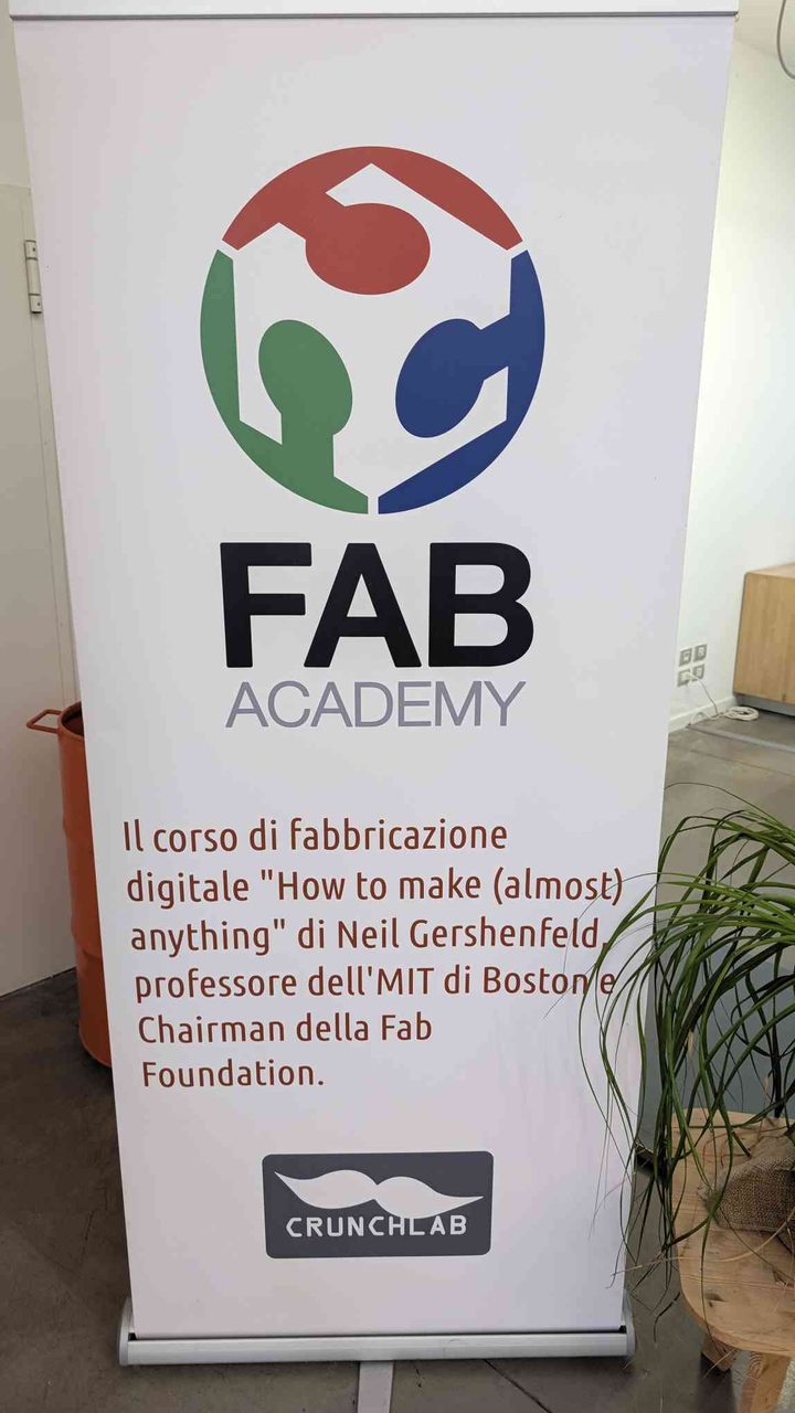 Fab Academy roll-up banner: "FAB ACADEMY" with Neil Gershenfeld credit and the CrunchLab logo at the bottom