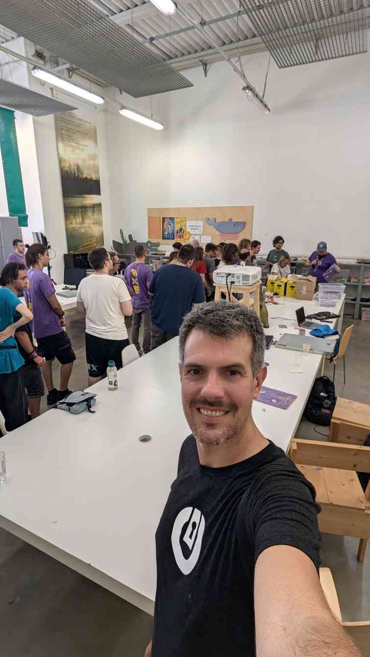 A second angle on the crowd — purple t-shirts everywhere, the projector setup, and the collaborative energy