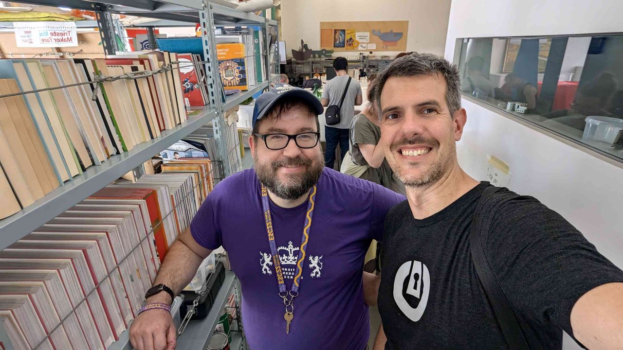 Luca Berton with Sebastiano Mestre — the ESC organizer with the lockpicking village lanyard, in the library/workspace area