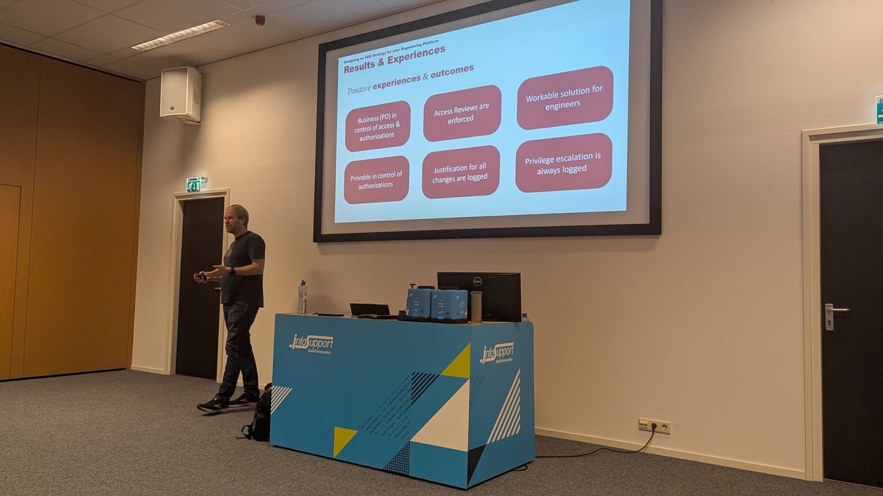 Results and Experiences slide at BitBash 2025 listing six outcomes: business (PO) in control of access, access reviews enforced, workable for engineers, provably in control, justification for all changes logged, and privilege escalation always logged