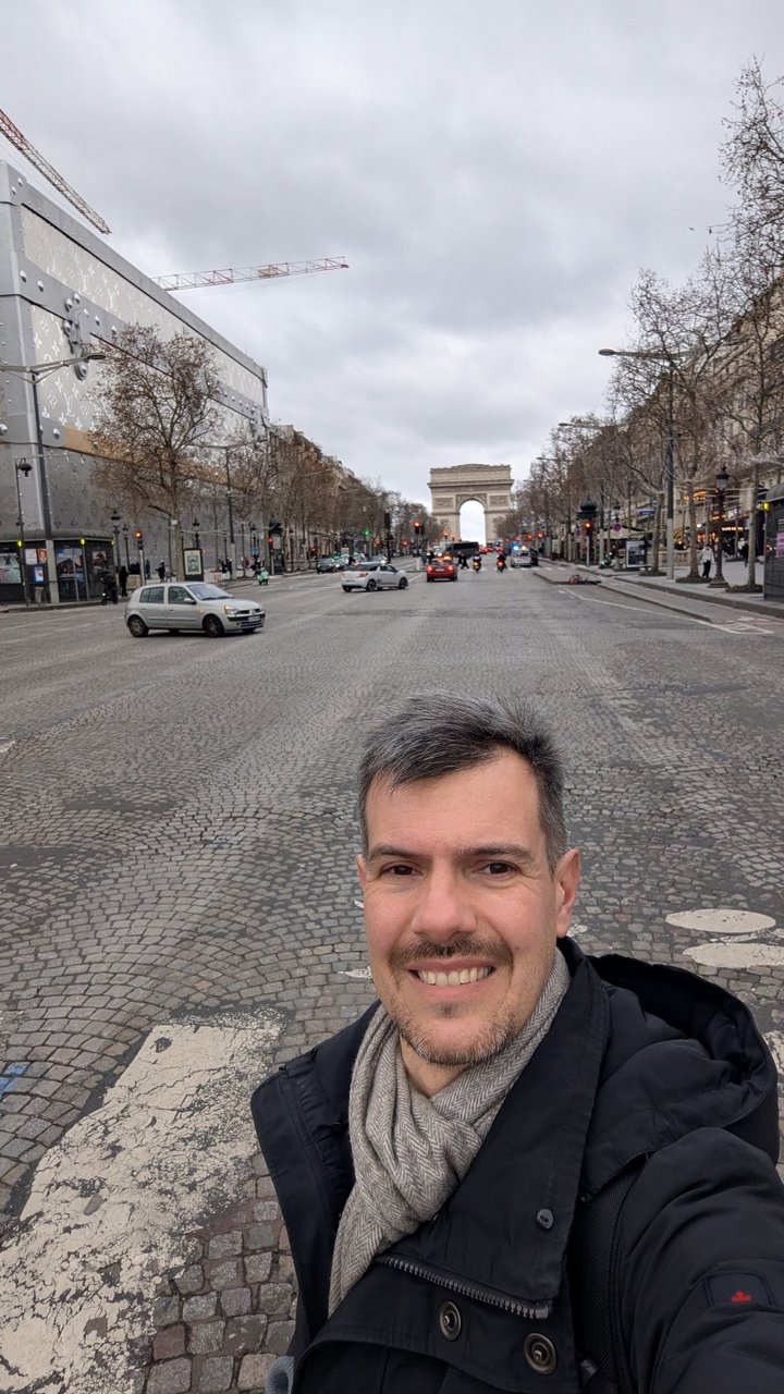 Luca Berton on the Champs-ĂlysĂ©es with the Arc de Triomphe at the end of the avenue