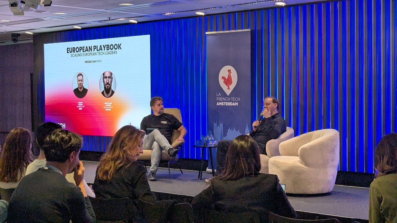 Two speakers seated on stage for the fireside chat, next to a slide reading European Playbook, Scaling European Tech Leaders, fireside chat with Andrey Khusid (Founder and CEO, Miro) and Sebastiaan Vaessen (Head of Strategy, Prosus), and a La French Tech Amsterdam banner