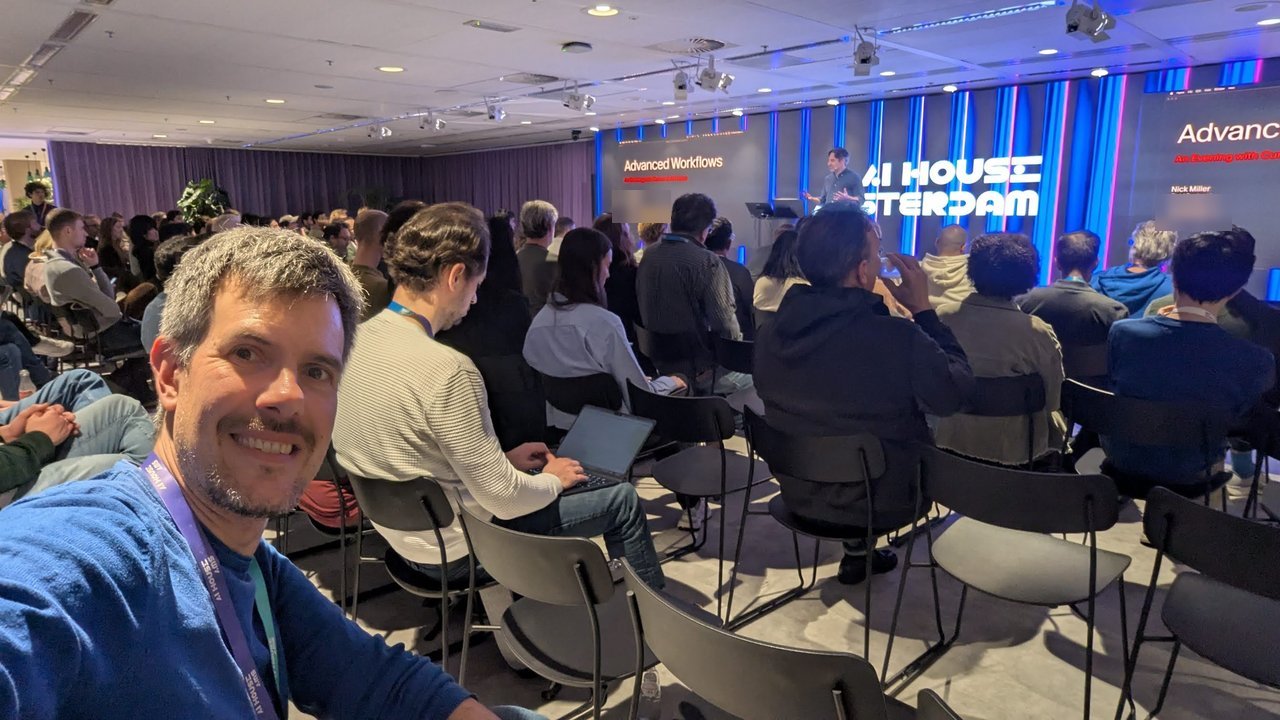 Luca Berton taking a selfie in the audience during the Cursor talk at AI House Amsterdam