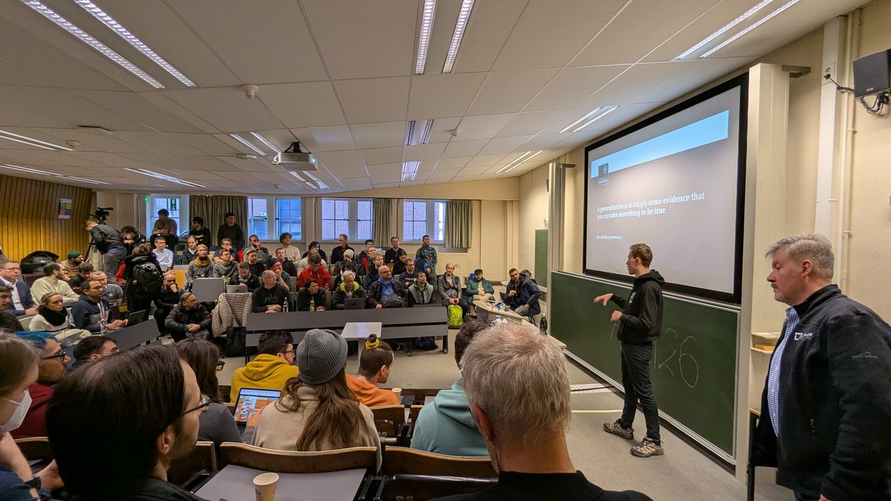 Jesse Wright presenting a slide that defines provenance as supplying evidence that something can be taken to be true, at FOSDEM 2025