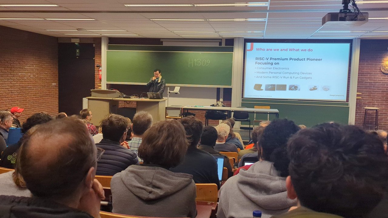 DeepComputing slide titled Who are we and What we do, RISC-V Premium Product Pioneer focusing on consumer electronics and modern personal computing devices, in room H.1309 at FOSDEM 2025