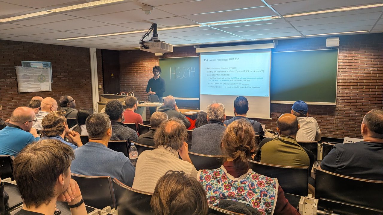 ISA profile readiness RVA23 slide listing the RV64GC baseline and riscv_hwprobe in room H.2214 at FOSDEM 2026
