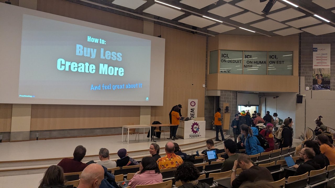 How to Buy Less Create More title slide with the FreeSewing.eu footer in a large FOSDEM 2026 auditorium