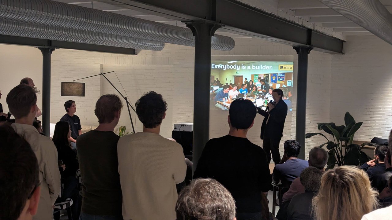 Speaker presenting the Miro slide Everybody is a builder to a standing audience at The Future of Product #3