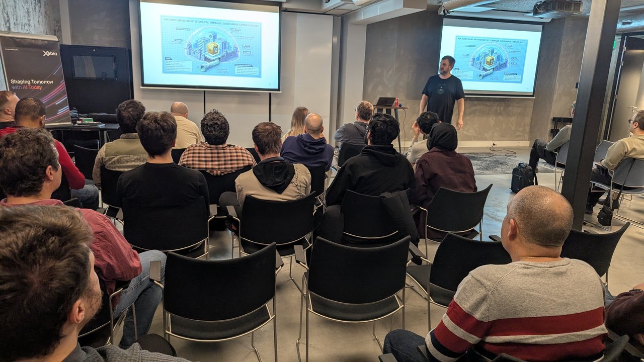 The ADK Agent Secure Architecture slide, with VPC, firewalls, Cloud Armor and private access around the agent, shown on both screens at the Xebia meetup in Amsterdam