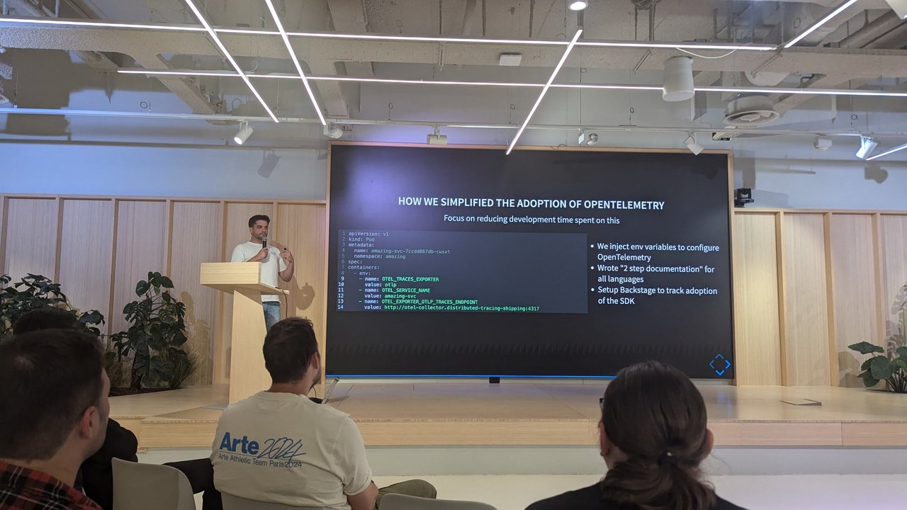 Slide titled How we simplified the adoption of OpenTelemetry showing Kubernetes env variables and three bullets