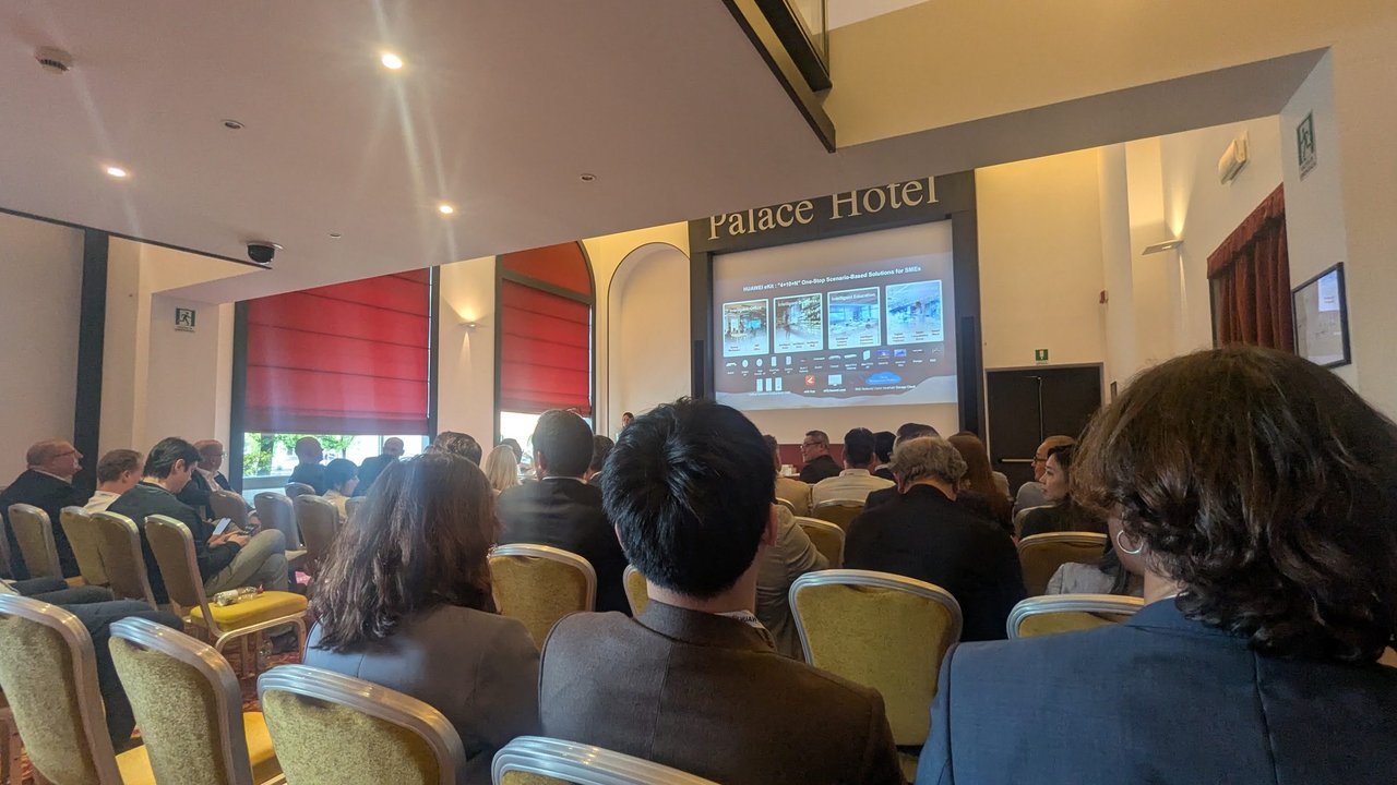 A full conference room at the Huawei Benelux & Ireland Partner Summit 2026, with the eKit SME solutions slide on the screen