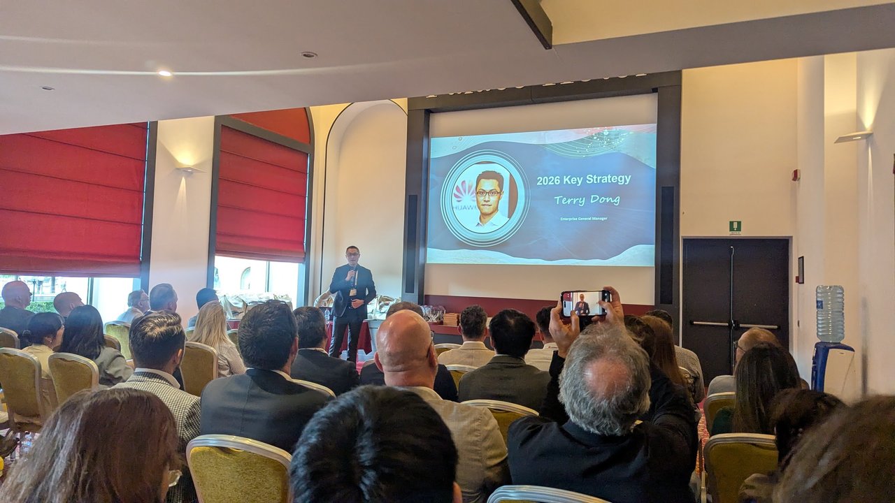 Terry Dong on stage in front of his 2026 Key Strategy title slide, with the audience in the foreground