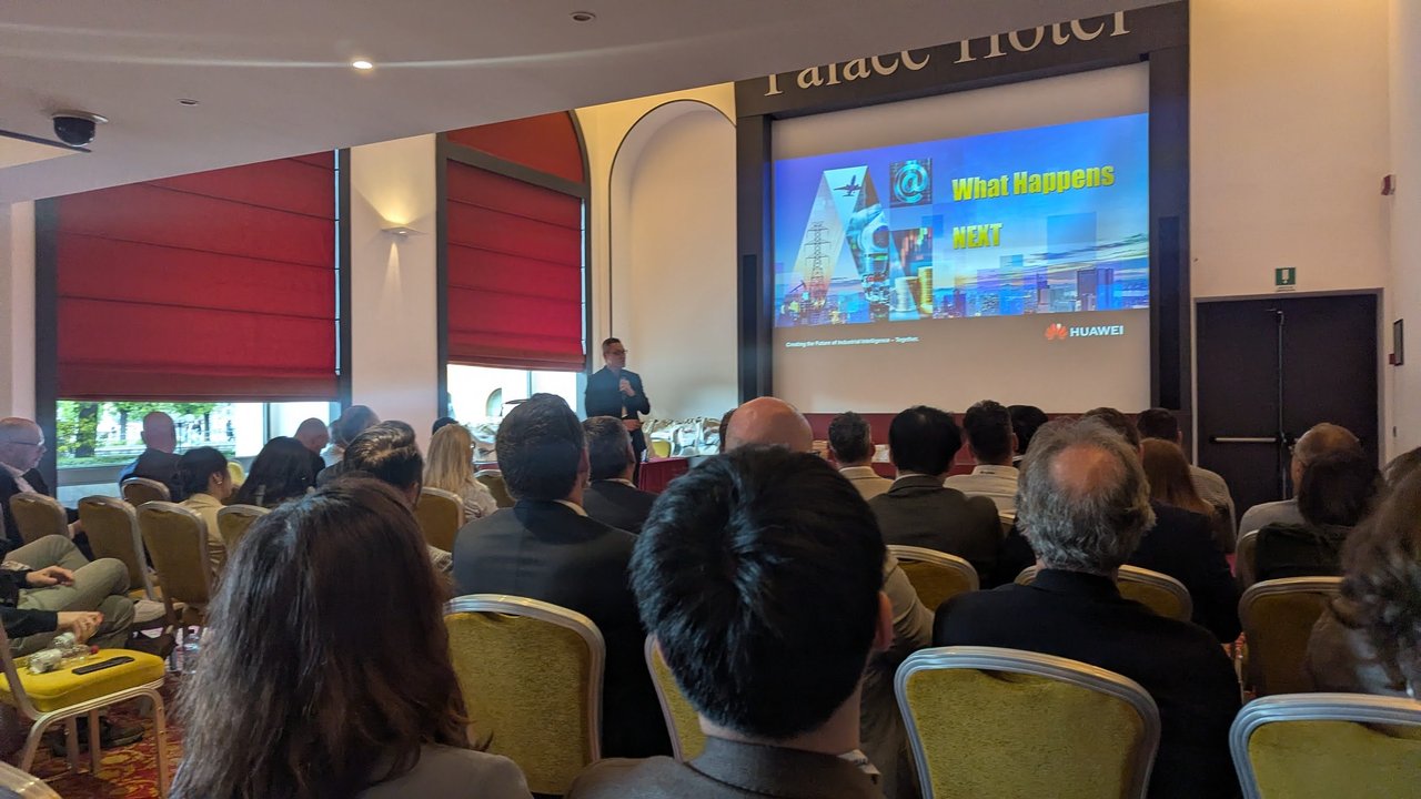 Huawei "What Happens NEXT" slide on screen in front of the partner audience