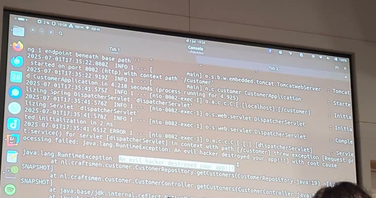 Projected terminal output showing a Spring Boot stack trace with an exception message about an evil hacker destroying the app