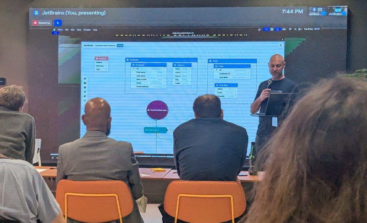 The SAAScade designer on screen: Customer, Address, Order and Line item entities with their fields, and a flow starting from an Authenticated user node