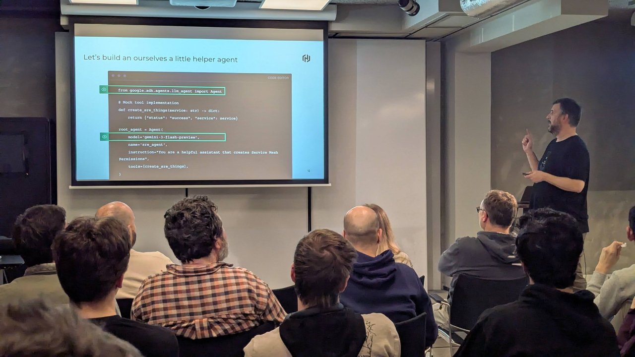 Speaker presenting an ADK helper agent code slide with an Agent, a gemini-3-flash-preview model and a mock create_sre_things tool at a Xebia meetup in Amsterdam