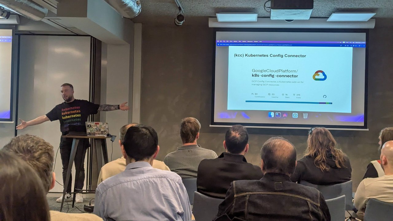 Speaker presenting the Kubernetes Config Connector slide with the GoogleCloudPlatform/k8s-config-connector repository card