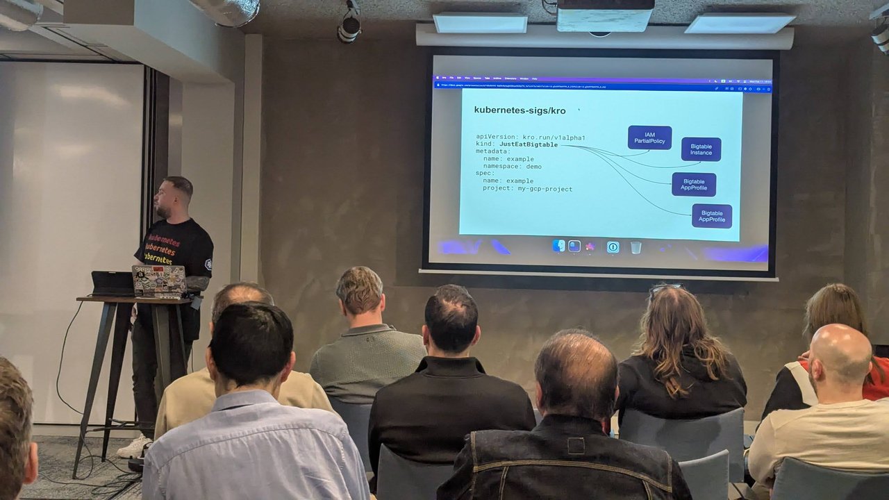 Slide titled kubernetes-sigs/kro showing a JustEatBigtable instance with apiVersion kro.run/v1alpha1 linked to an IAM PartialPolicy, a Bigtable Instance and two Bigtable AppProfiles
