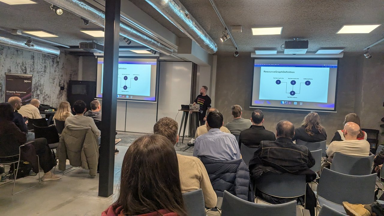 ResourceGraphDefinition slide at the Xebia meetup in Amsterdam, showing two BigTable AppProfiles and an IAMPartialPolicy connected to a BigTable Instance