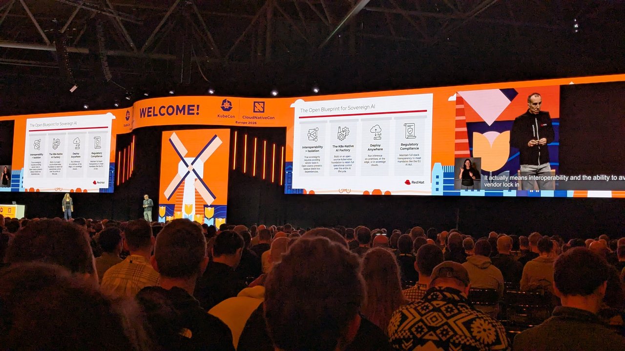 Red Hat keynote slide at KubeCon Europe 2026 titled The Open Blueprint for Sovereign AI, with four columns and two speakers on the stage below
