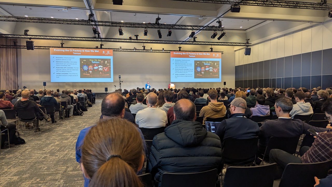 A KubeCon Europe 2026 session slide titled Evolving the CI Factory and How We Met Tekton, listing declarative, ephemeral execution, Kubernetes API controlled and GitOps compatible requirements