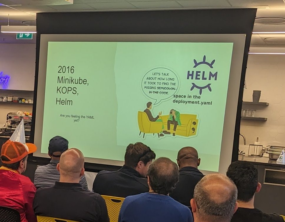 A slide reading 2016 Minikube, KOPS, Helm with the Helm logo and a cartoon about a missing space in deployment.yaml