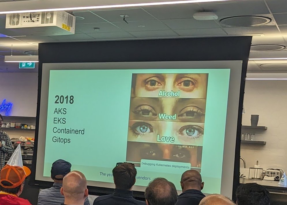 A slide reading 2018 AKS, EKS, Containerd, Gitops next to a meme about debugging Kubernetes deployments
