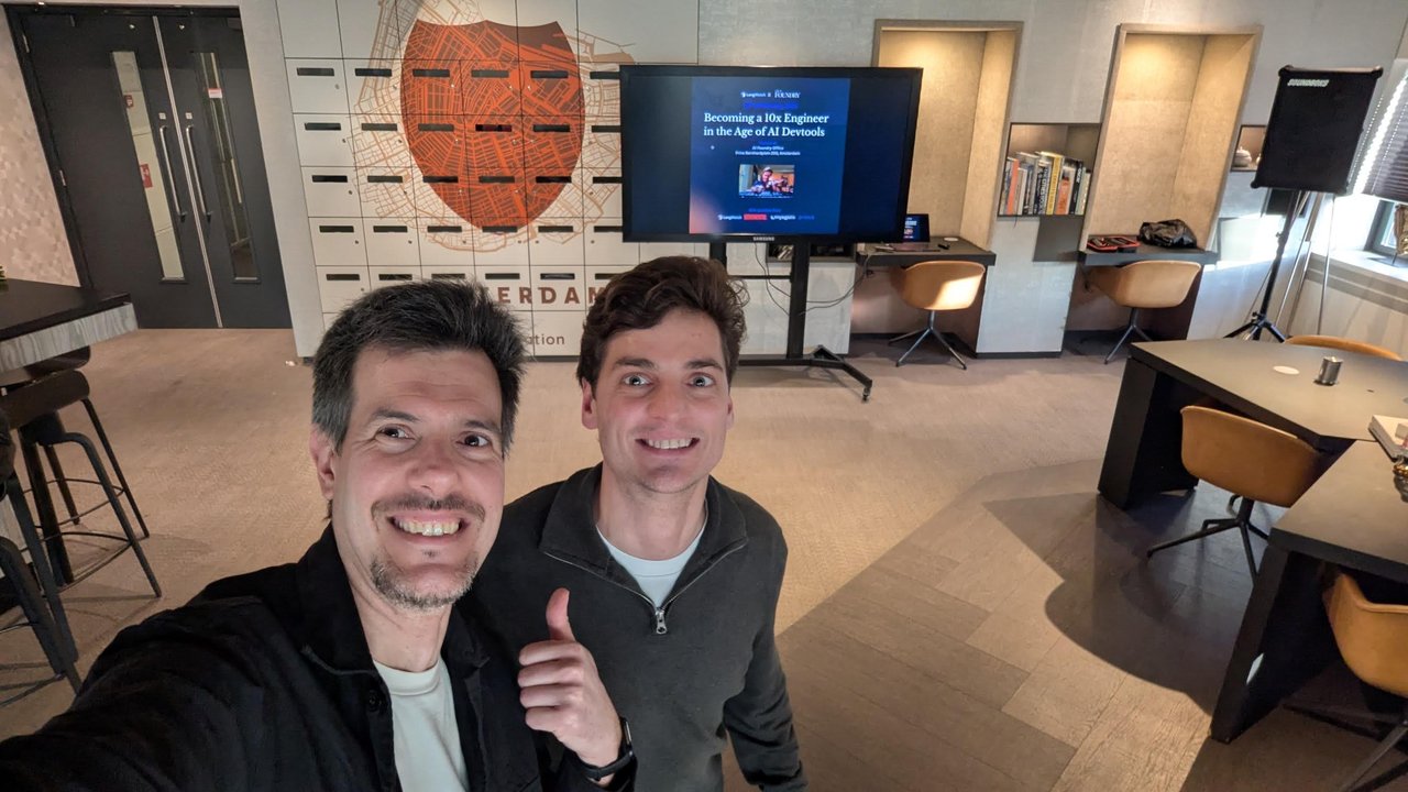 Luca Berton with another attendee in front of the title slide of Becoming a 10x Engineer in the Age of AI Devtools at the AI Foundry office