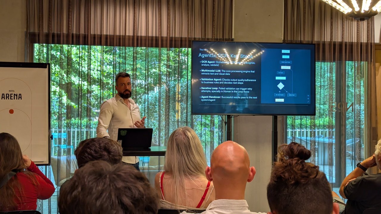 Speaker beside a slide titled Agentic OCR Key Steps with a flowchart of OCR agent, multimodal LLM and validation agent