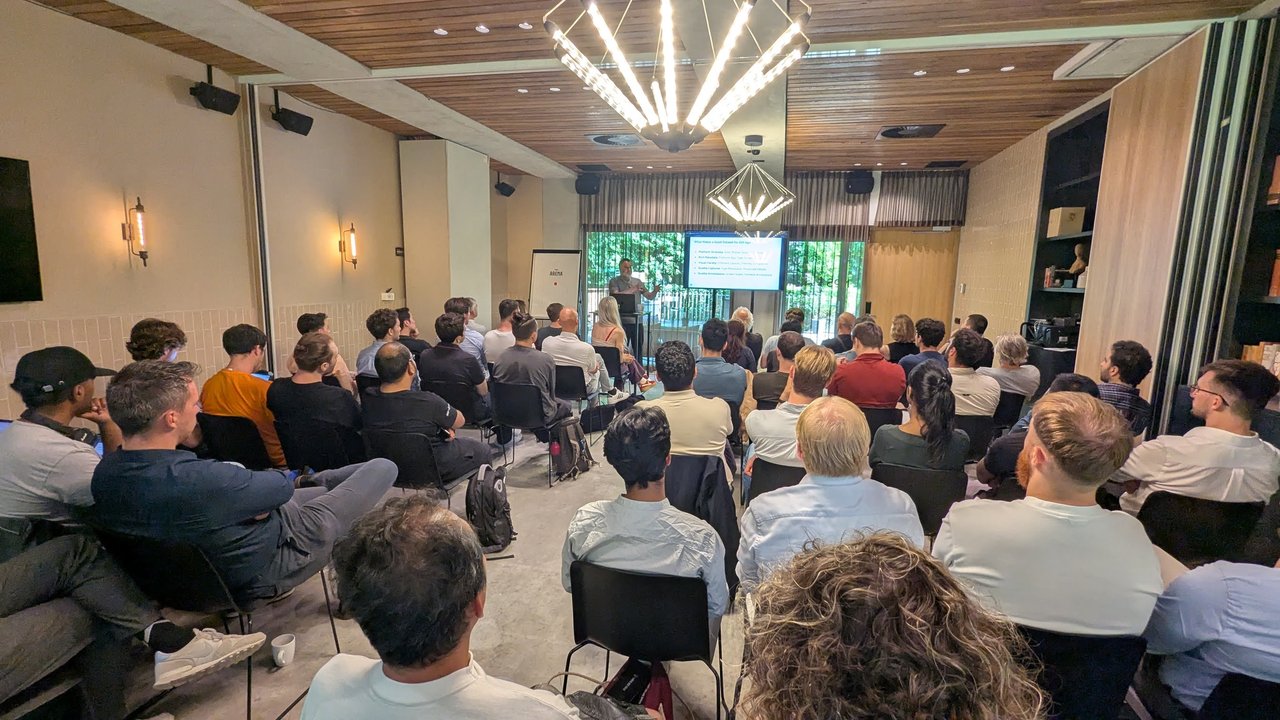 Speaker presenting a slide titled What Makes a Good Dataset for GUI Agents to a full room at the LlamaIndex meetup in Amsterdam