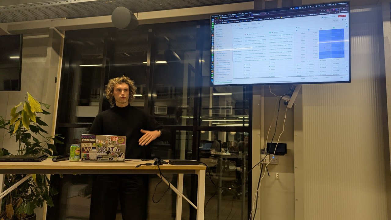 The orq.ai experiment view at AI Tinkerers Amsterdam with old and new prompt variants on two models side by side and a cost value filled in for each response