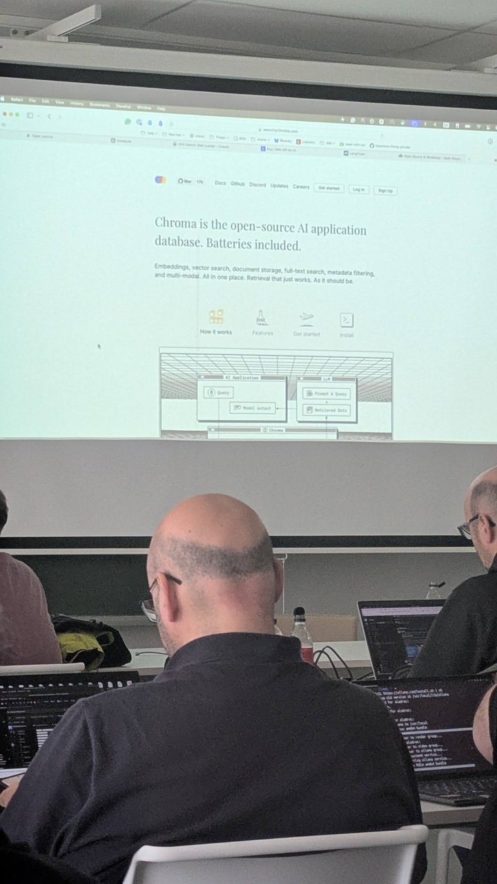 The Chroma homepage projected at CfgMgmtCamp 2025, describing an open-source AI application database with embeddings, vector search, document storage, full-text search and metadata filtering