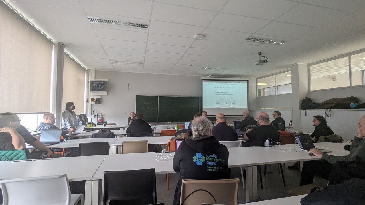 A classroom at CfgMgmtCamp 2025 in Ghent during the hands-on InstructLab session, with attendees at laptops and the Chroma website on the projector screen