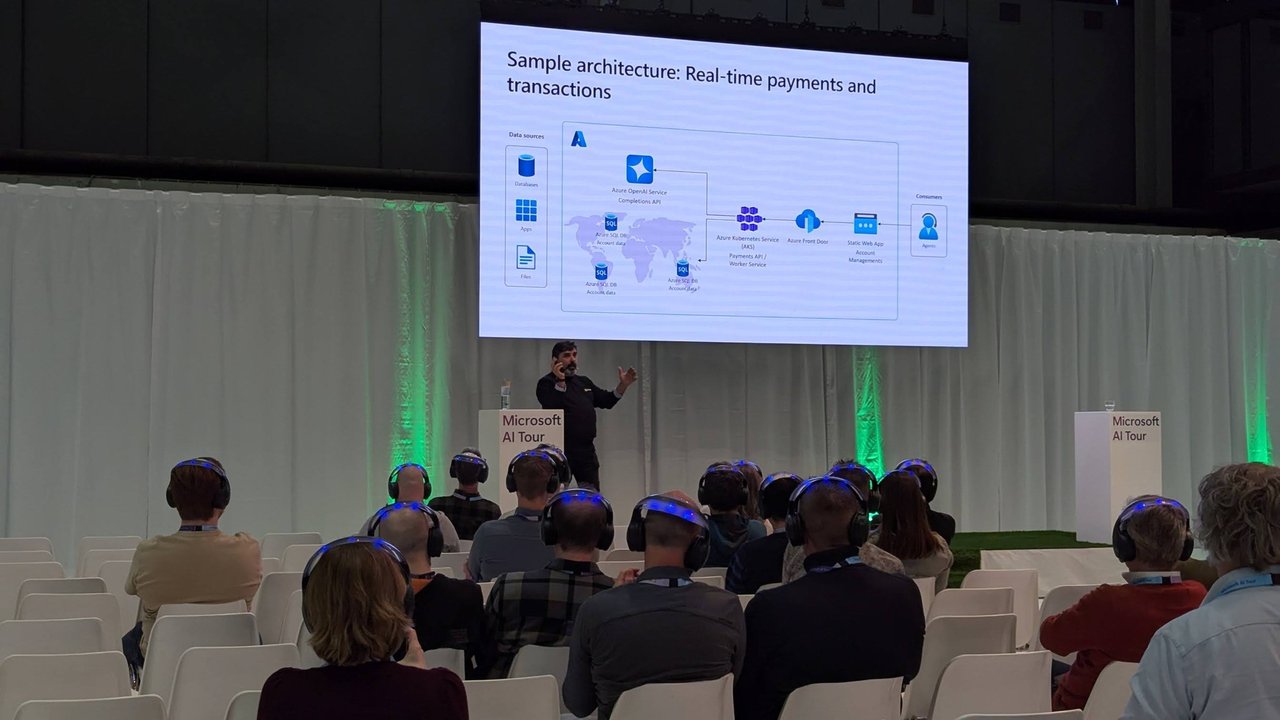 Slide titled Sample architecture: Real-time payments and transactions, with data sources and an API layer, shown above the audience