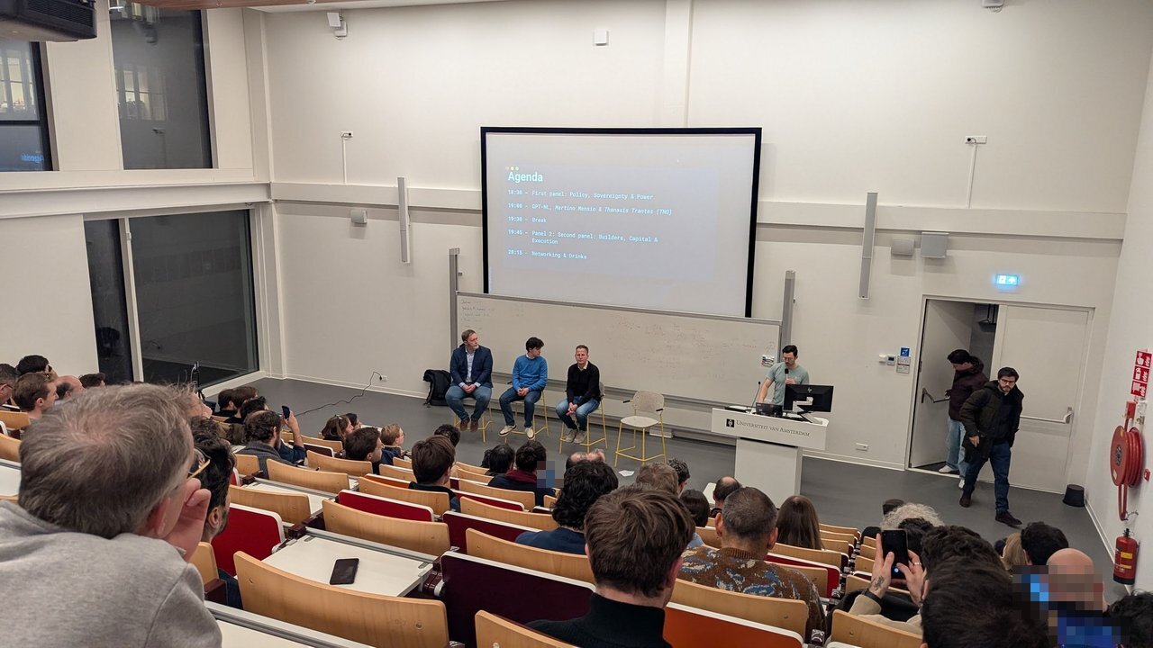 Agenda slide for the MLOps Community Amsterdam AI Strategy and Sovereignty Special above the first panel, seen from the back of a full lecture hall
