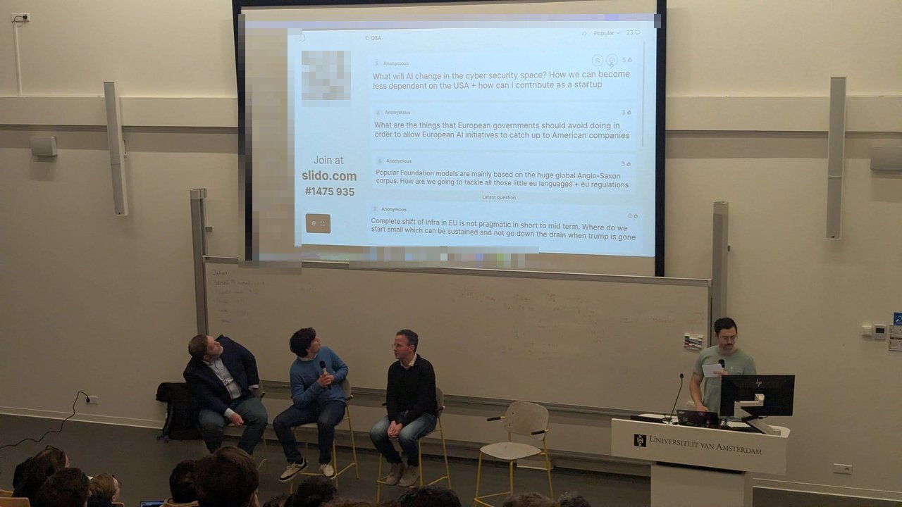 Slido Q&A screen with anonymous audience questions about EU AI infrastructure, dependence on the USA and small European languages, above the panel