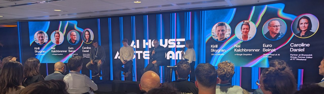 AI House Amsterdam stage with the second panel and screens naming Kirill Skrygan of JetBrains, Nal Kalchbrenner, Euro Beinat of Prosus and Caroline Daniel of Brunswick Group