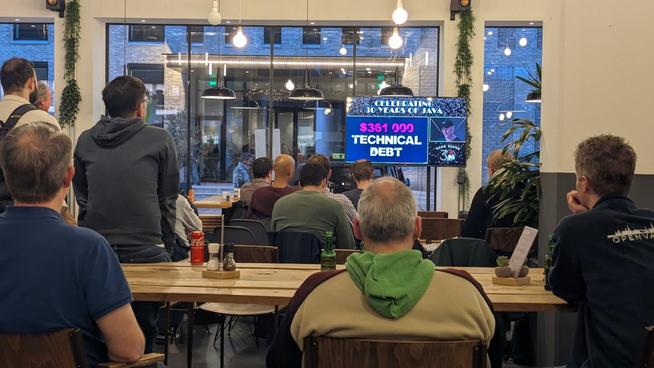 Celebrating 30 Years of Java talk with a $361 000 Technical Debt slide on the screen and the audience at long tables