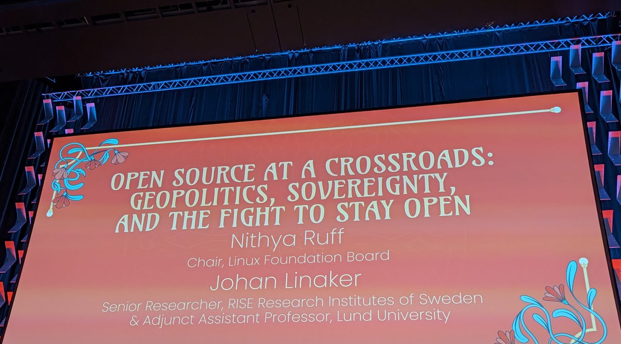 Keynote title slide: Open Source at a Crossroads, Nithya Ruff and Johan Linåker