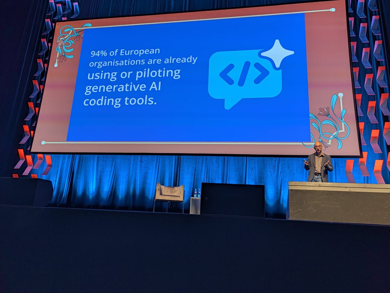 Luca Berton's photo of the 94 percent generative AI coding tools adoption keynote slide at Open Source Summit Europe 2026