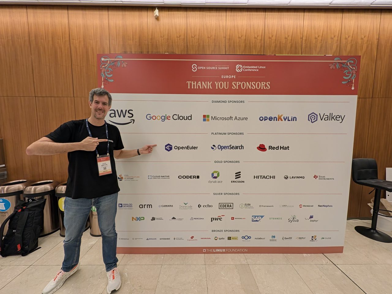 Luca Berton in front of the sponsor wall at the Prague Congress Centre
