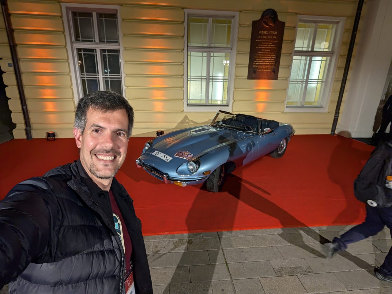 Luca Berton next to a classic Jaguar E-Type at the Žofín Palace entrance